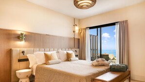 A hotel room with a large bed, a wooden bench, a bedside table, a wall-mounted light fixture, and a view of the sea. - Aubamar Palma Resort (Palma de Mallorca)