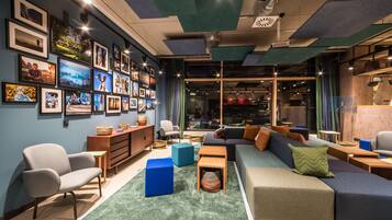 A modern lounge area with a sofa, chairs, and a coffee table.