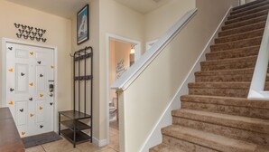 A staircase with carpeted steps leading to a landing. - Paradise Palms-ru1074 (Kissimmee)