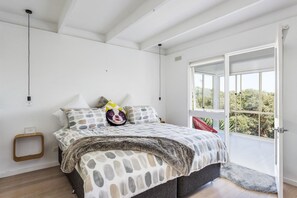 A bedroom with a bed, a window, and a door. - At Agnes Ave Blairgowrie (Blairgowrie)