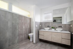 A modern bathroom with a large mirror, two sinks, and a toilet. - At Agnes Ave Blairgowrie (Blairgowrie)