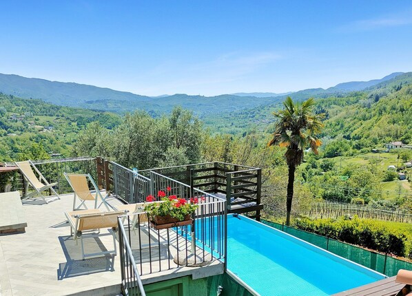 A pool area with a view of a mountainous landscape.