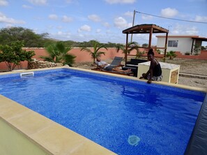 A swimming pool with two lounge chairs and a wooden gazebo. - Full equipped bungalows with swimming pool, wifi, garden for 2 to 5 people (Morro)