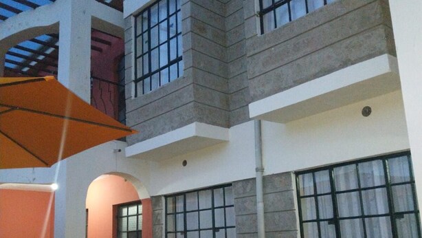 A multi-story building with large windows and a balcony. - Machakos Luxury Suites (Machakos)