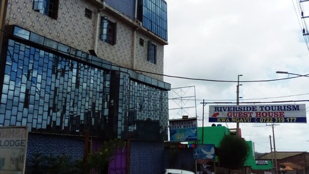 A multi-story building with a Riverside Tourism Guest House sign. - Riverside Tourism Guest House (Embu)