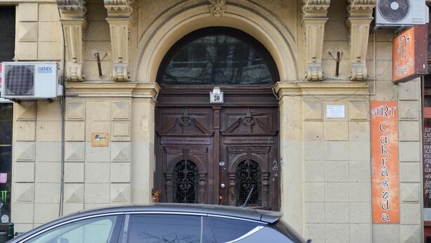 A building with a large, ornate entrance featuring a double door with a number '30' above it. - Diamonds Apartments (Budapest)