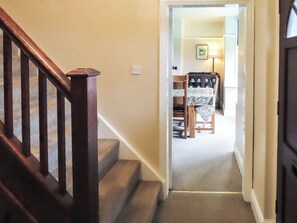 A carpeted staircase leading to a dining area with a table and chairs. - What more could you ask for than a spacious family home in a rural haven. (Yanwath, near Penrith)