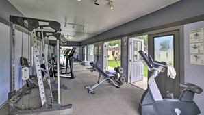 A gym with cardio machines, weightlifting equipment, and mirrors.
