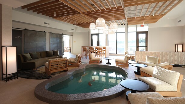 A spacious living area with a pool, wooden ceiling beams, and modern furniture. - Cedartree Hotel Portland Hillsboro (Hillsboro)