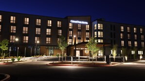 A hotel with a modern facade, multiple windows, and a well-lit entrance area. - Cedartree Hotel Portland Hillsboro (Hillsboro)