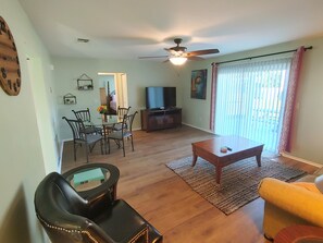 Relax in this inviting living space with a sofa, chair, and dining table.