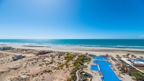 Un resort con piscina, acceso a la playa y vistas al océano.