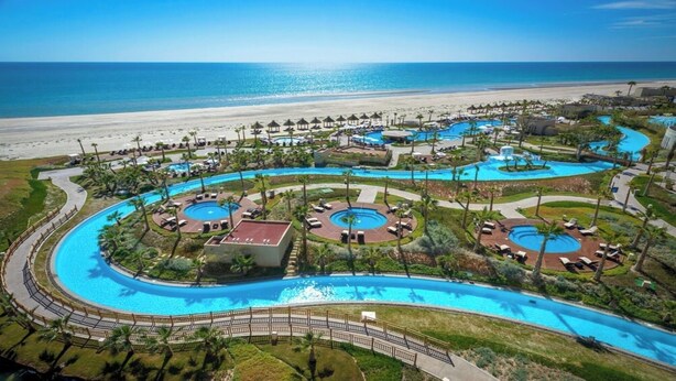 A resort with multiple swimming pools, a beach, and a view of the ocean. - Fully Remodeled, The Suite at Rocky Point 2 Ocean front (Puerto Penasco)