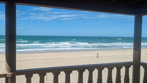 A beach view from a covered area with a railing. - Fully Remodeled, The Suite at Rocky Point 2 Ocean front (Puerto Penasco)