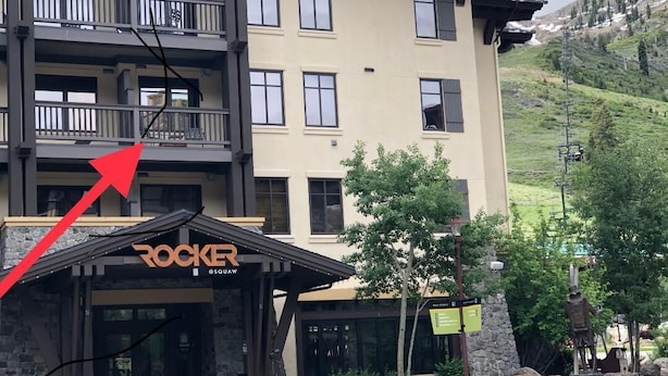 A multi-story building with a sign reading "ROCKER @SQUAW".