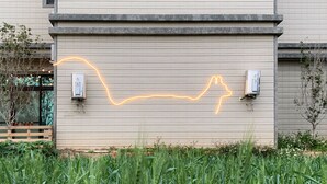A building with a simple, modern design, featuring a flat facade and a small window. - White Cat B&B (Jinning)