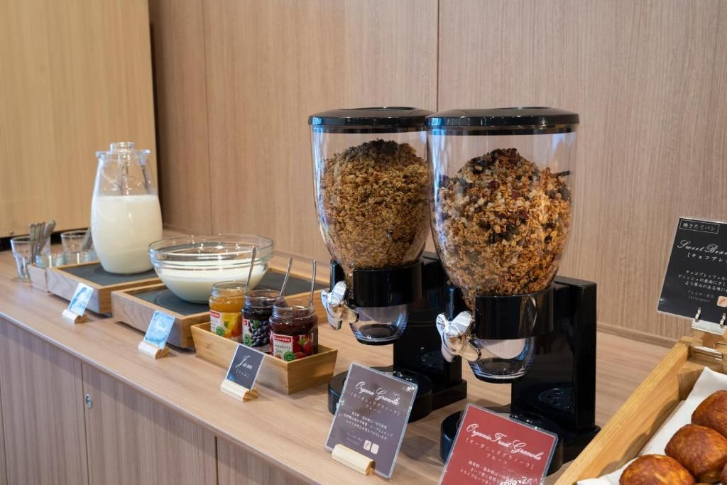 A breakfast bar with a milk dispenser, granola, and a sign for organic granola.