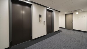 A hallway with three elevator doors, each marked with floor numbers. -  Washington R&B Hotel Sendai Higashiguchi (Sendai)