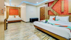 A hotel room with two beds, a wooden headboard, a patterned wall, and a tiled floor. - The K11 Hotels (Chennai)