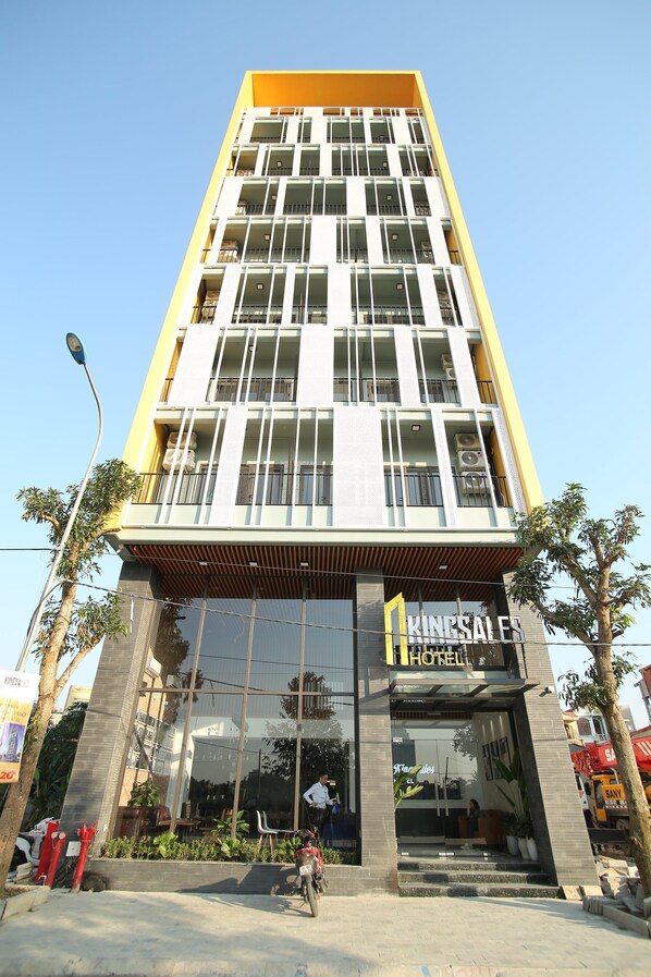 A multi-story hotel with a modern design, featuring large windows and a prominent entrance. - Kingsales Hotel (Thanh Hoa)