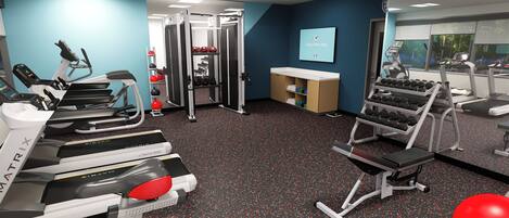 A gym with treadmills, weight machines, and a mirror.