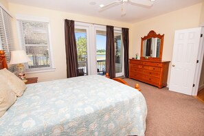 A bedroom with a bed, dresser, and a door. - Soundside, Private Pool, Community Amenities, CC10, Fore-Shore (Corolla)