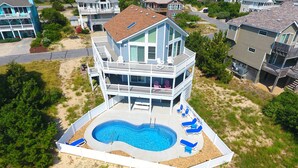 A two-story house with a swimming pool, multiple balconies, and a beach view. - Oceanside, Dogs Welcome, Private Pool, 800 ft to Beach Access, OS2E, Simply A-Mazzing (Corolla)