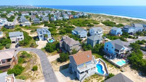 A coastal residential area with houses, a beach, and a clear view of the ocean. - Oceanside, Dogs Welcome, Private Pool, 800 ft to Beach Access, OS2E, Simply A-Mazzing (Corolla)