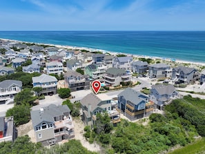 A coastal residential area with beachfront properties, including houses with balconies and a beach in the background. - Oceanside, Hot Tub, Close to Beach, Community Pool, CP4, Crown Palace (Corolla)