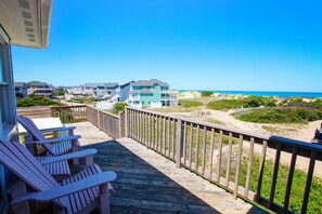 A wooden deck with Adirondack chairs and a view of beach houses and the ocean. - Semi-Oceanfront, Close to Beach, Private Pool, Pool Table, OS5Q, Olympus (Corolla)
