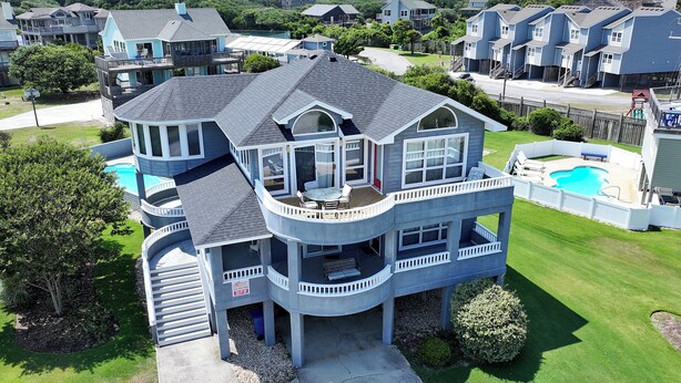 A multi-story house with a large deck, a swimming pool, and a well-maintained lawn. - Semi-Oceanfront, Private Pool, Hot Tub, Close to Beach Access, GF2, Touch of Grey (Duck)