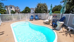 A swimming pool with a white deck, surrounded by a white fence, and blue chairs and umbrellas. - Oceanside, Private Pool, Hot Tub, Screened Porch, WC940, Whalin (Corolla)