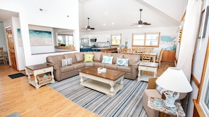 A spacious living area with a sectional sofa, a coffee table, and a dining table with chairs. - Semi-Oceanfront, Private Pool, H Tub, Pool Table, WL864, Porch Coffee Paradise (Corolla)