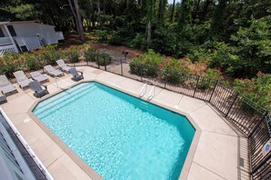 A rectangular swimming pool with a black metal fence, surrounded by a deck with lounge chairs. - Semi-Soundfront, Rec Room, Private Pool, Hot Tub, 566, Finnegans Wake (Corolla)