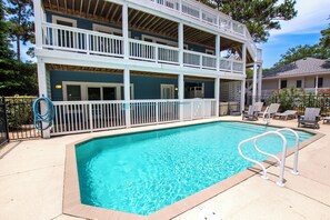 A two-story building with a swimming pool, outdoor seating, and a fenced area. - Semi-Soundfront, Rec Room, Private Pool, Hot Tub, 566, Finnegans Wake (Corolla)
