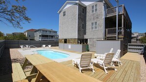A pool area with a wooden deck, lounge chairs, and a pool. - Oceanside, Private Pool, Sun Deck, Hot Tub, OS3N, The Lone Star Fish (Corolla)