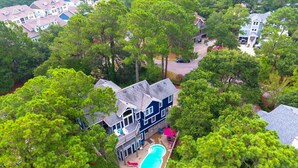 A large house surrounded by dense trees, with a visible swimming pool and multiple decks. - Semi-Soundfront, Private Pool, Hot Tub, Community Amenities, 507, N-2-Wishn (Corolla)