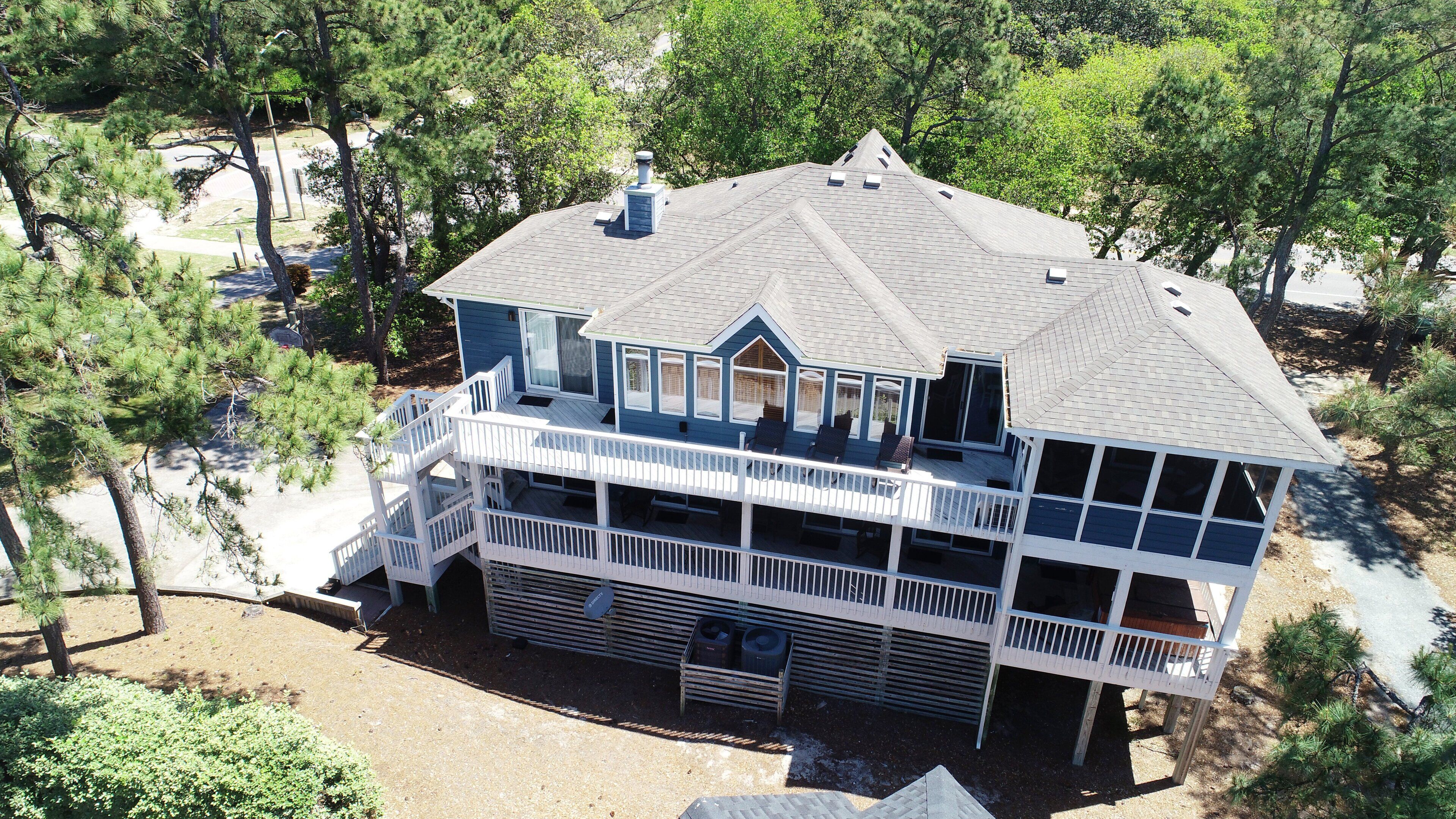 A two-story house with a balcony, a chimney, and a garage.