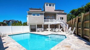 A two-story house with a swimming pool, outdoor furniture, and a wooden fence. - Oceanside, Priv Pool, poolside grilling, sun decks, SEA6, Morningstar (Duck)