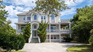 A two-story house with a front porch, a covered front porch area, and a driveway.