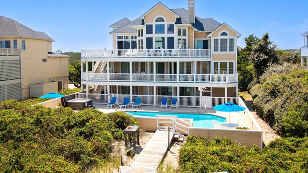 A two-story house with a balcony, a swimming pool, and a deck. - OCEANFRONT, Ocean views, beach access, Pool, PI139, Pine Haven (Corolla)