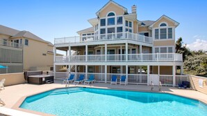 A two-story house with a swimming pool, a covered patio, and a fenced deck. - OCEANFRONT, Ocean views, beach access, Pool, PI139, Pine Haven (Corolla)