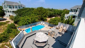 A rooftop pool with a hexagonal deck, surrounded by a wooden deck and lounge chairs. - Semi-Oceanfront, Private Pool with big pool deck, Close to Beach, PI12, A Shore Thing (Corolla)