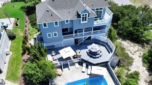 A large two-story house with a swimming pool, deck, and multiple outdoor seating areas. - Semi-Oceanfront, Private Pool with big pool deck, Close to Beach, PI12, A Shore Thing (Corolla)