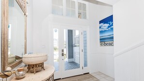 A bathroom with a large mirror, a round sink, and a decorative bird sculpture. - Semi-Oceanfront, Private Pool with big pool deck, Close to Beach, PI12, A Shore Thing (Corolla)