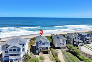 A beachfront property with multiple houses, a beach in the background, and a clear sky. - OCEANFRONT, Ocean Views, ELEVATOR, Private Beach Walkway, BB14, Heart Of Duck (Duck)