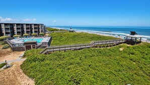 A beachfront hotel with a pool, beach access, and a pier. - Oceanfront, Community Pool and Beach Accesses, Ocean Views, C326D, Our Point Of View (Duck)