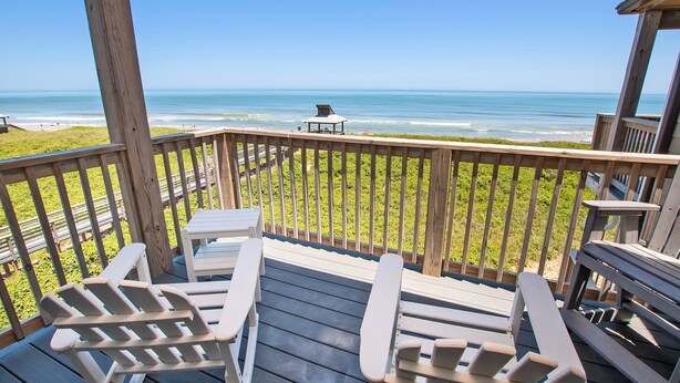 A wooden deck with Adirondack chairs and a table overlooking a beach. - Oceanfront, Community Pool and Beach Accesses, Ocean Views, C326D, Our Point Of View (Duck)