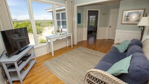 Flat-screen TV, DVD player, foosball, books