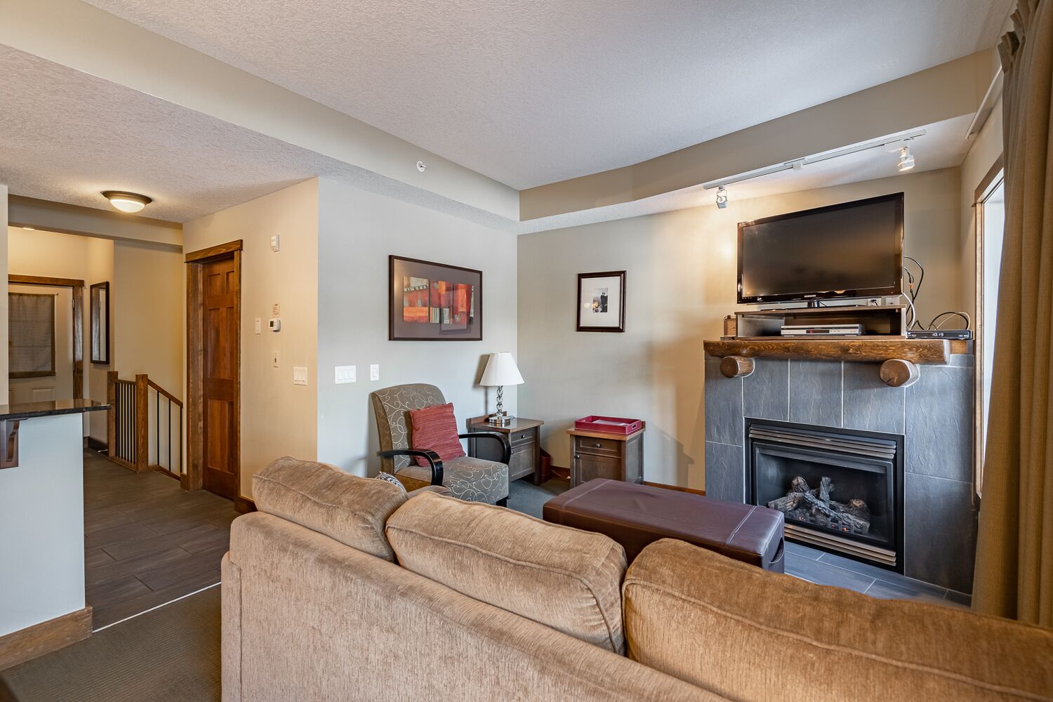 A living room with a fireplace, a television, and a sofa.